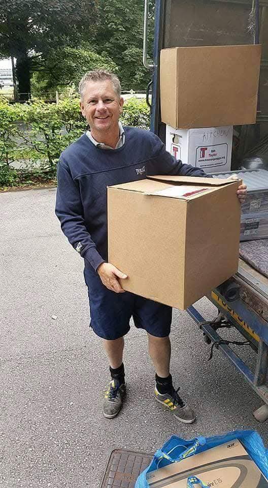 Image of Carl moving a box for a customer